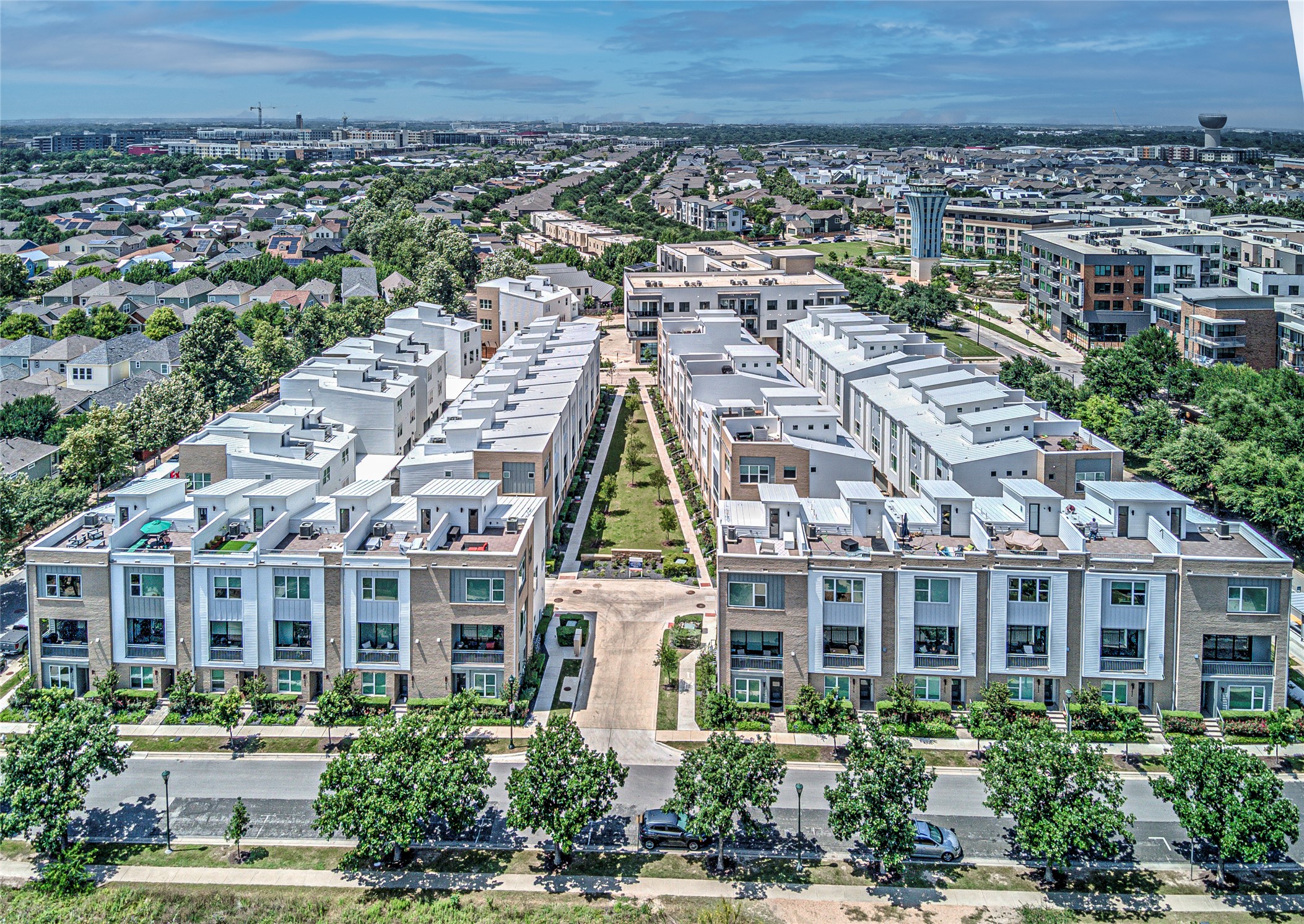 2805 McCurdy Street, Unit 14 Austin, TX 78723 - Photo 39 of 40 An aerial perspective reveals a vibrant residential community with modern townhomes lining a green parkway.