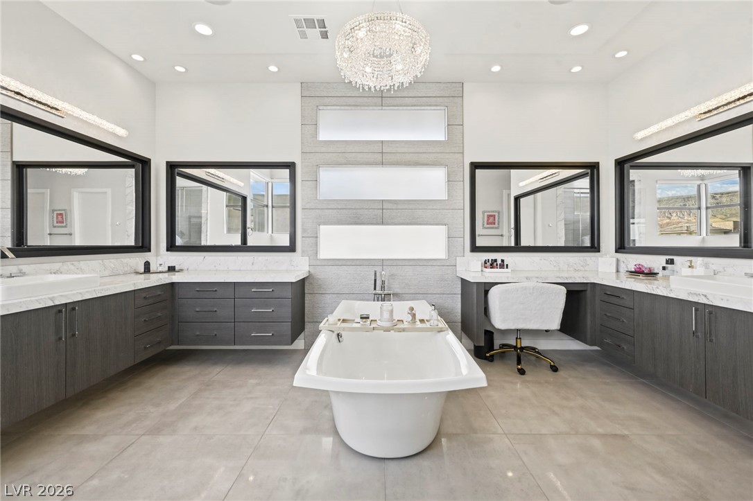 4208 Lapis Ridge Court Las Vegas, NV 89135 - Photo 26 of 61 Polished tile flooring and a freestanding tub anchor this symmetrical, contemporary bath retreat.