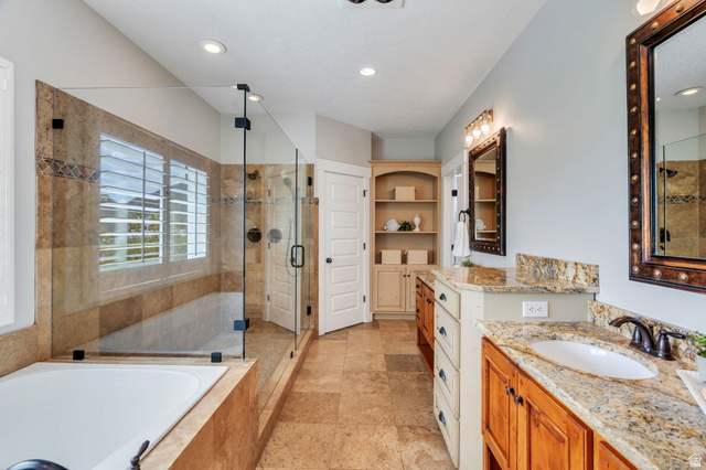 1355 West 1000 South Mapleton, UT 84664 - Photo 19 of 74 Full bath with two vanities, a stall shower, a garden tub, and light stone finish flooring
