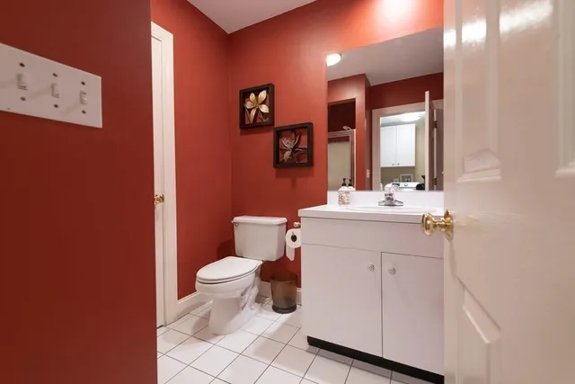 a bathroom with a sink mirror vanity and toilet