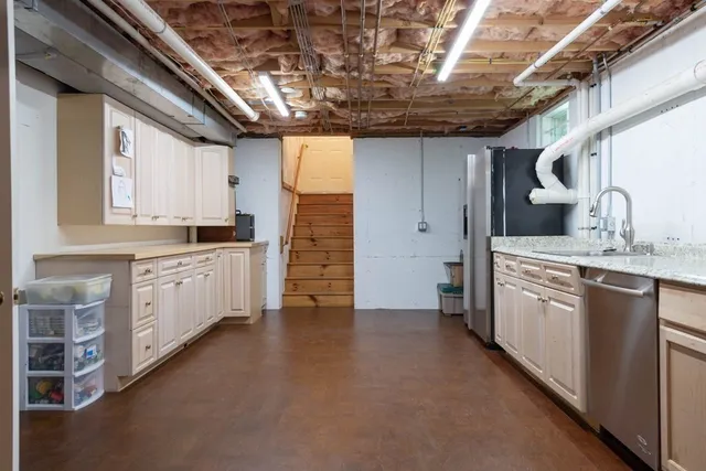 a large kitchen with stainless steel appliances and cabinets