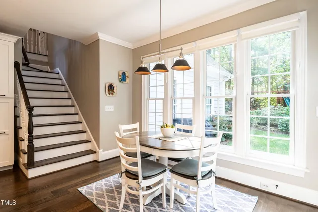 a view of a dining room with furniture window and wooden floor