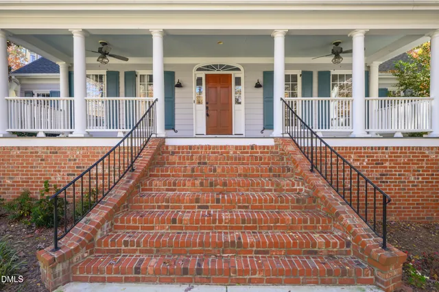 a view of a brick house with wooden floor and windows