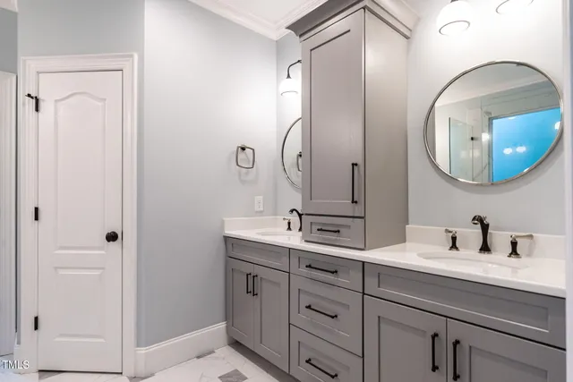 a bathroom with a double vanity sink and mirror