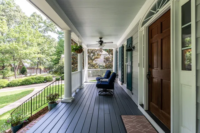 a view of a balcony with chairs and wooden floor
