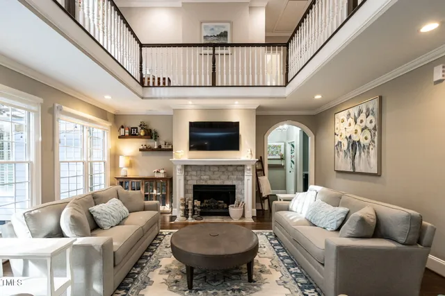 a living room with furniture fireplace and a large window