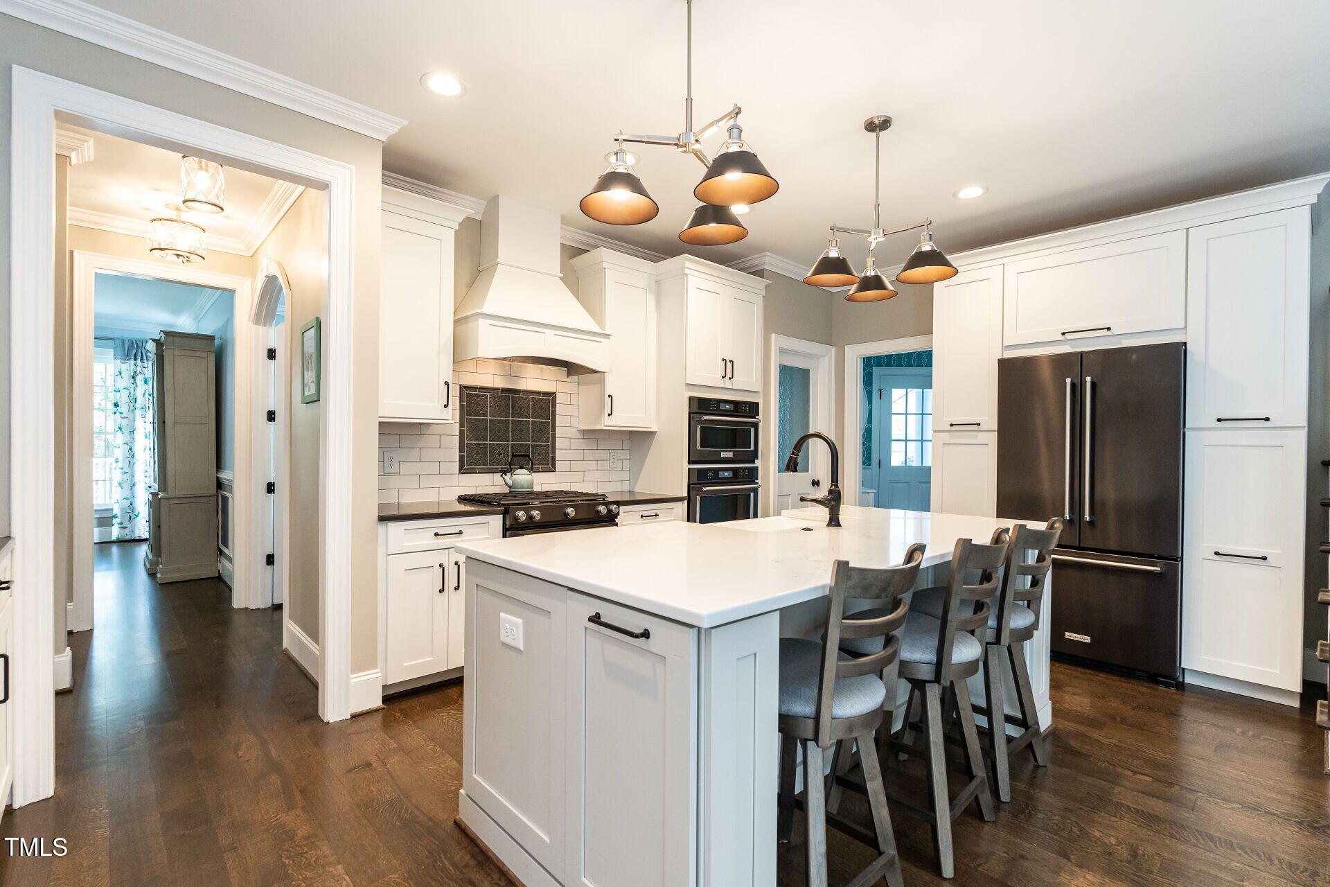 1228 Dorleath Court Raleigh, NC 27614 - Photo 10 of 47 a kitchen with stainless steel appliances a stove a table a refrigerator and cabinets