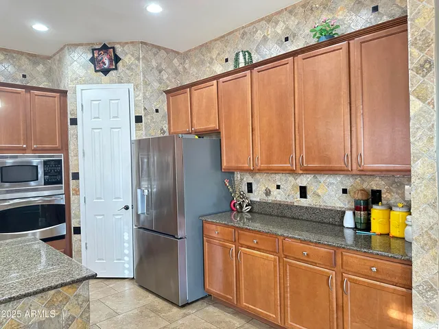 a kitchen with stainless steel appliances a refrigerator sink and cabinets