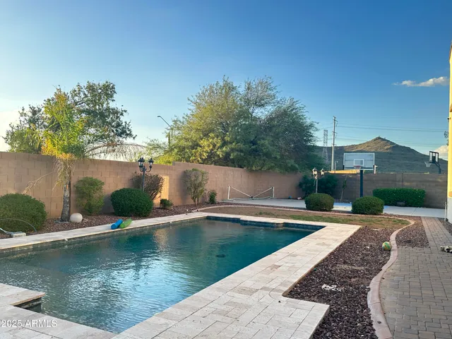 a view of a swimming pool with a yard