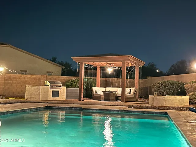 a house view with swimming pool in front of it