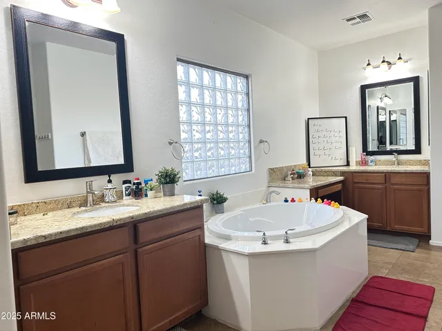 a white bath tub sitting next to a bathroom sink
