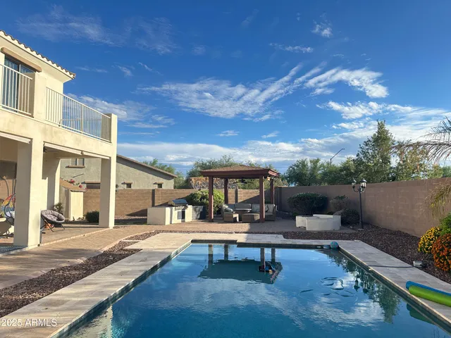 a view of a patio with dining table and chairs with a yard