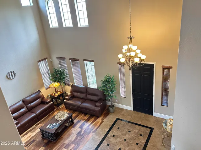 a living room with furniture and a chandelier