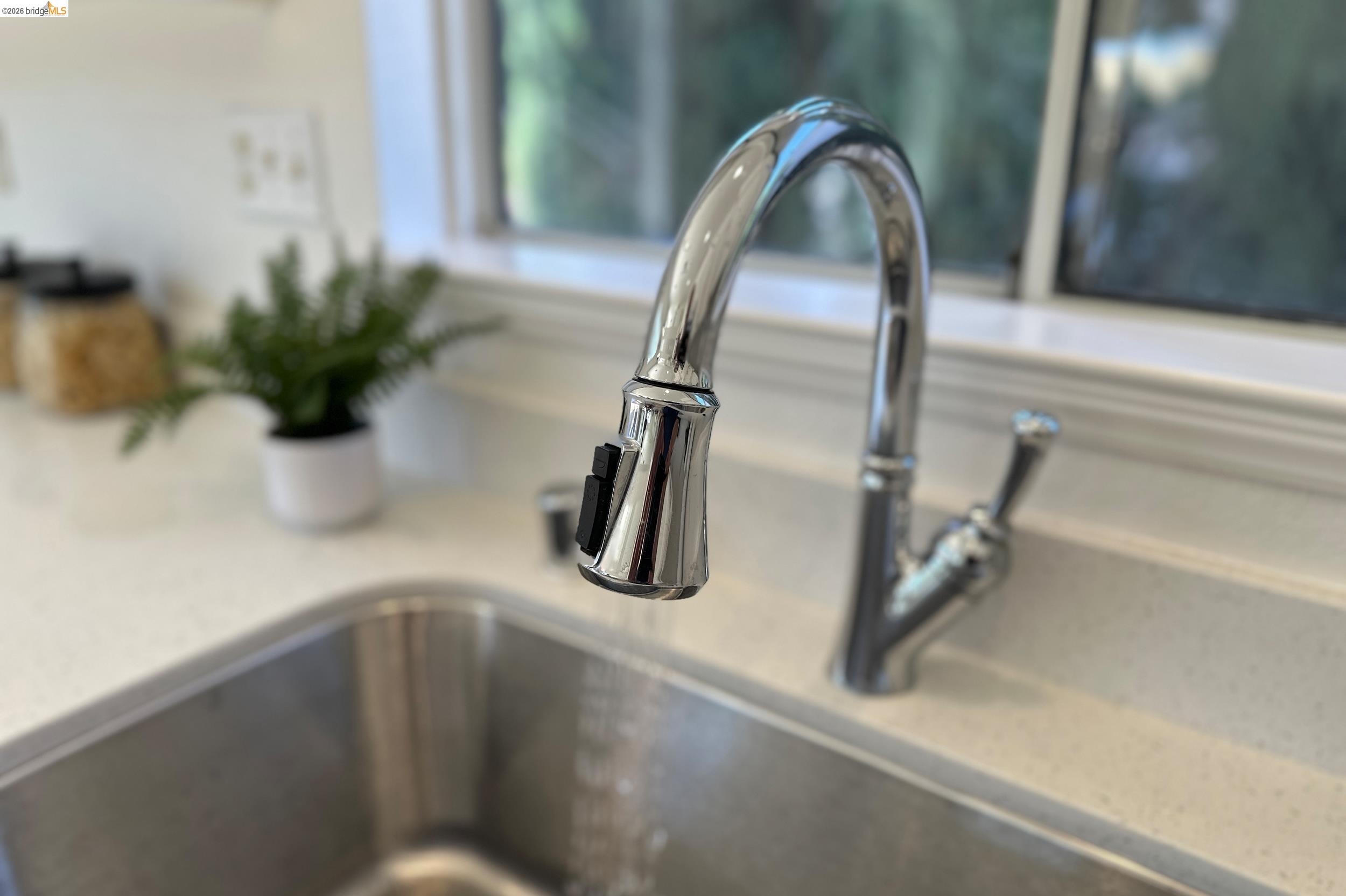 512 Burdick Drive Bay Point, CA 94565 - Photo 16 of 50 Stainless steel undermount sink with a high-arc chrome faucet, featuring a pull-down sprayer and a single-lever handle