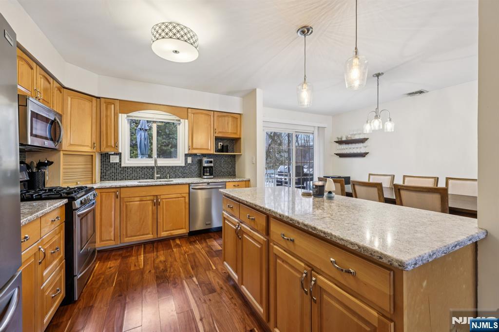 4 Birch Road Ringwood, NJ 07456 - Photo 17 of 41 a large kitchen with stainless steel appliances granite countertop a sink a stove and a wooden floors