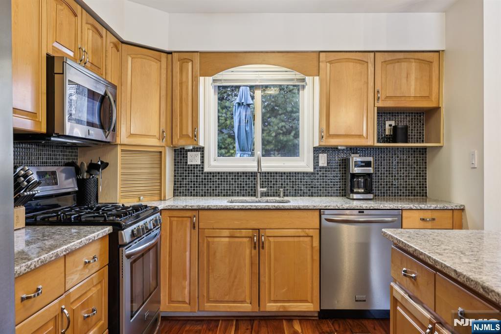 4 Birch Road Ringwood, NJ 07456 - Photo 19 of 41 a kitchen with granite countertop a stove a sink and a wooden cabinets
