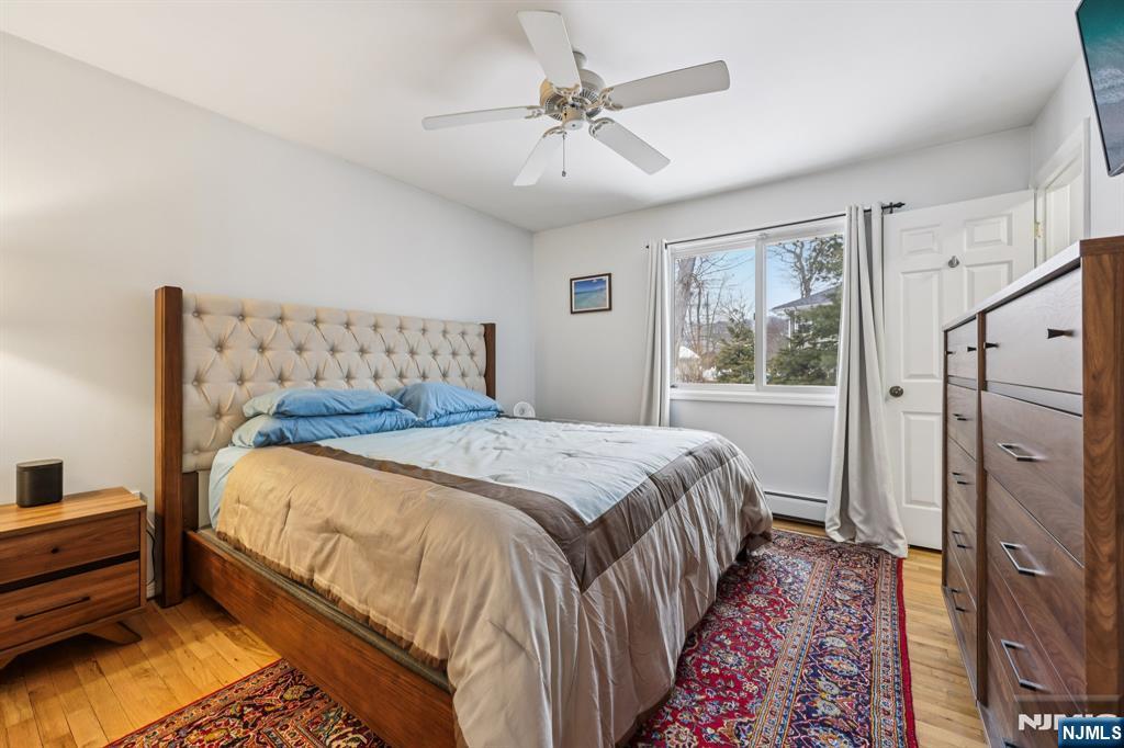 4 Birch Road Ringwood, NJ 07456 - Photo 27 of 41 a bedroom with a bed and a chandelier