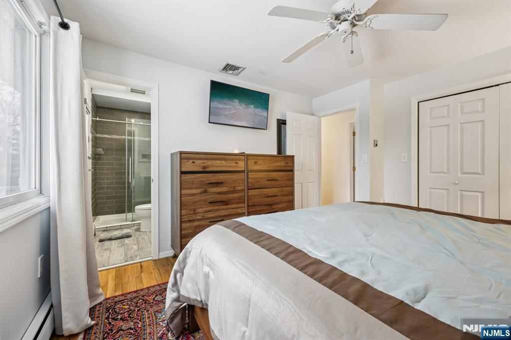 4 Birch Road Ringwood, NJ 07456 - Photo 29 of 41 a bedroom with a bed and a chandelier