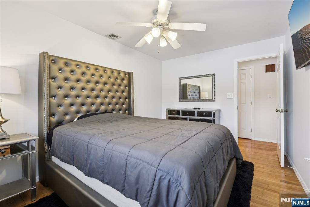 4 Birch Road Ringwood, NJ 07456 - Photo 32 of 41 a bedroom with a bed and a chandelier