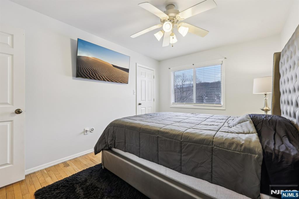 4 Birch Road Ringwood, NJ 07456 - Photo 33 of 41 a bedroom with a bed and a chandelier