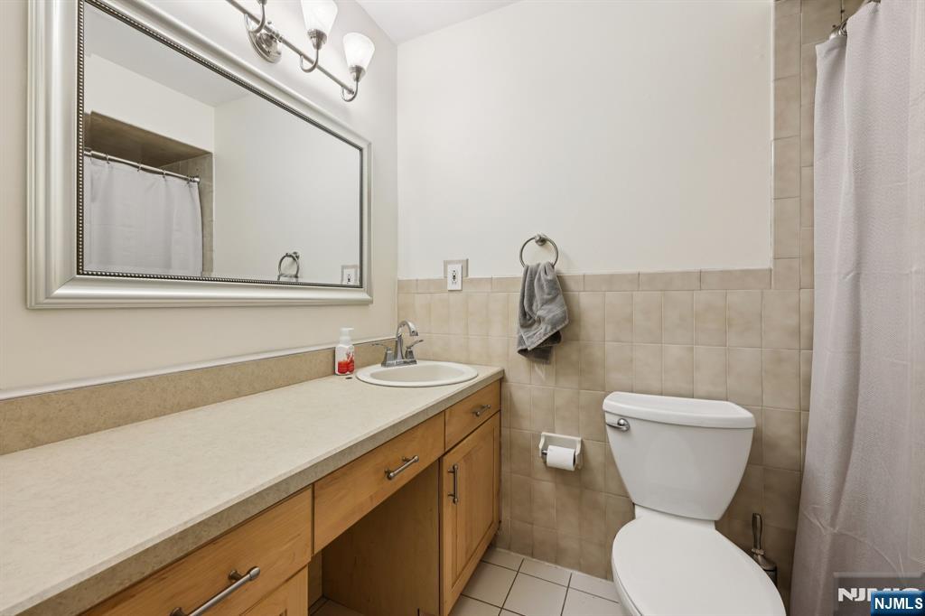 4 Birch Road Ringwood, NJ 07456 - Photo 36 of 41 a bathroom with a toilet sink and mirror