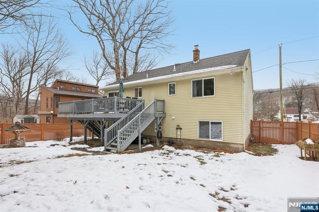 4 Birch Road Ringwood, NJ 07456 - Photo 39 of 41 a roof deck with table and chairs and wooden fence