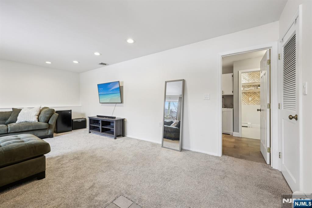 4 Birch Road Ringwood, NJ 07456 - Photo 8 of 41 a living room with furniture and a refrigerator