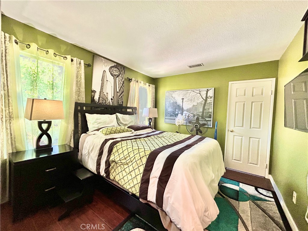 24702 Montevista Circle Valencia, CA 91354 - Photo 12 of 25 a bedroom with a bed and wooden floor