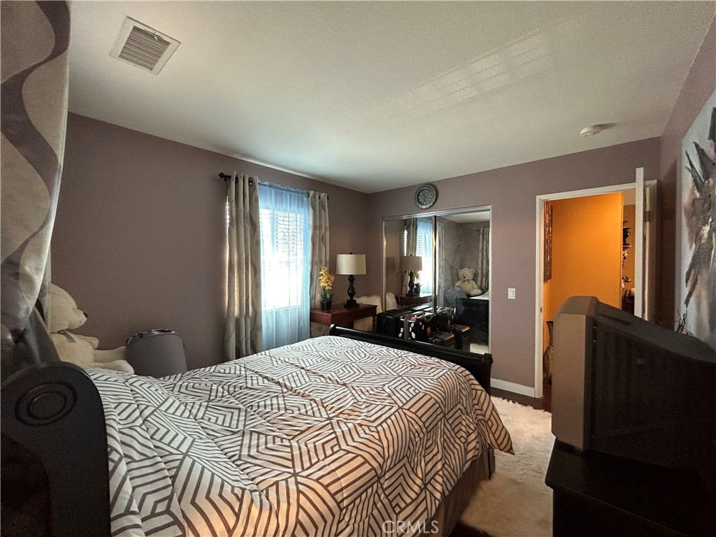 24702 Montevista Circle Valencia, CA 91354 - Photo 15 of 25 a bedroom with a bed and wooden floor