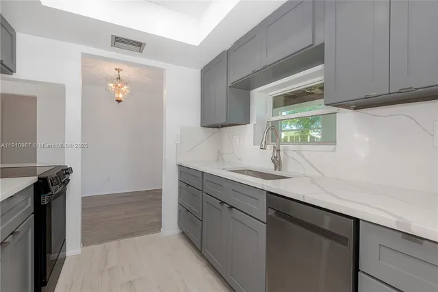 a kitchen with a sink and a refrigerator