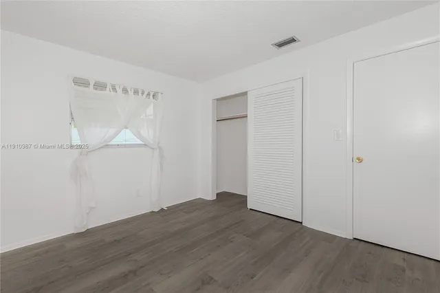 an empty room with wooden floor