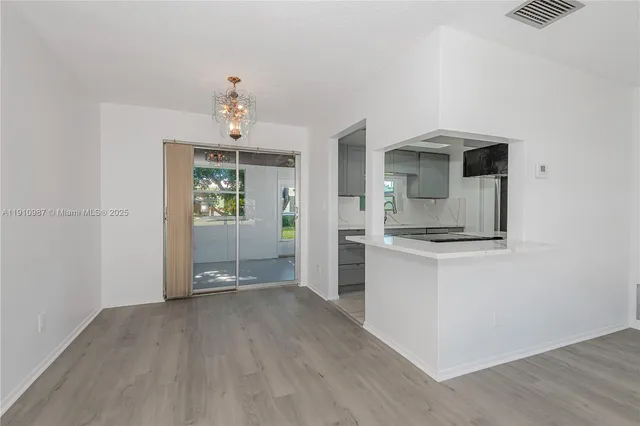 a view of a kitchen with a sink cabinet and a window