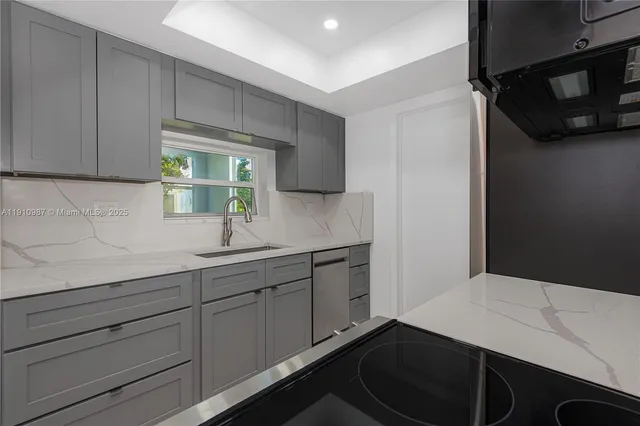 a kitchen with a sink and cabinets