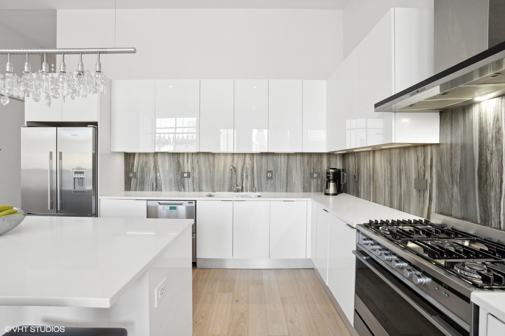 128 South Aberdeen Street, Unit PHN Chicago, IL 60607 - Photo 12 of 43 a kitchen with stainless steel appliances white cabinets a sink and a stove