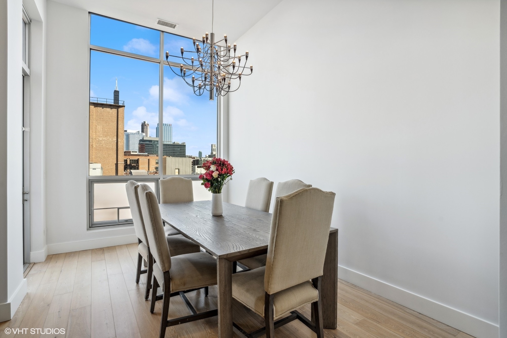 128 South Aberdeen Street, Unit PHN Chicago, IL 60607 - Photo 14 of 43 a view of a dining room with furniture and wooden floor