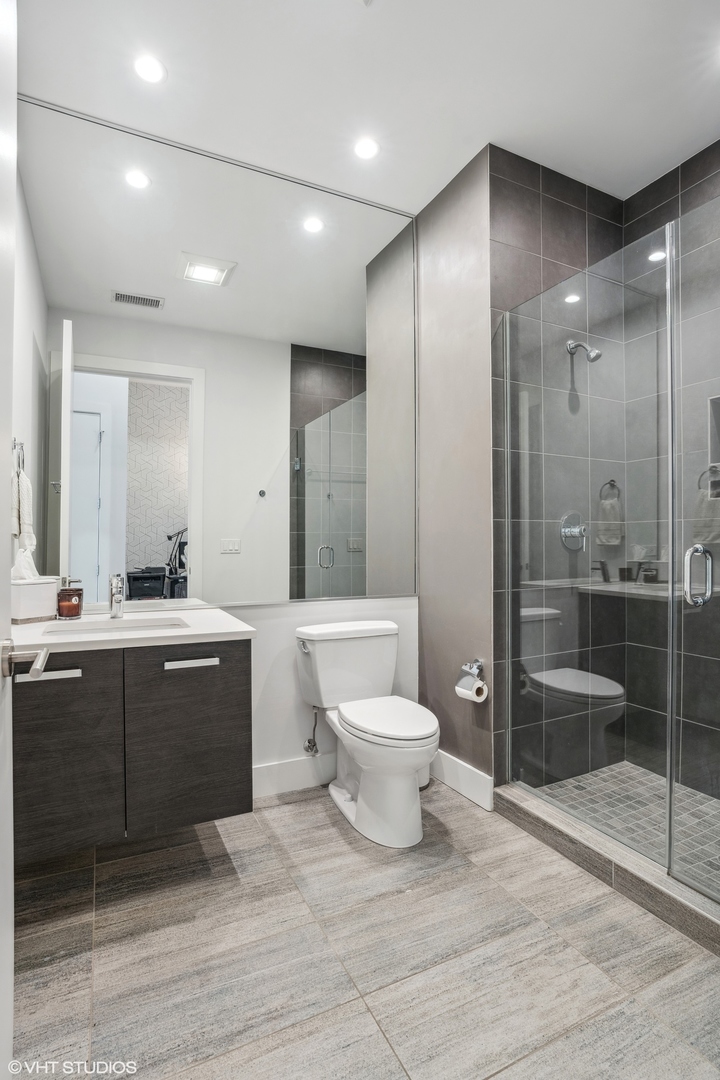 128 South Aberdeen Street, Unit PHN Chicago, IL 60607 - Photo 25 of 43 a bathroom with a sink a toilet and shower