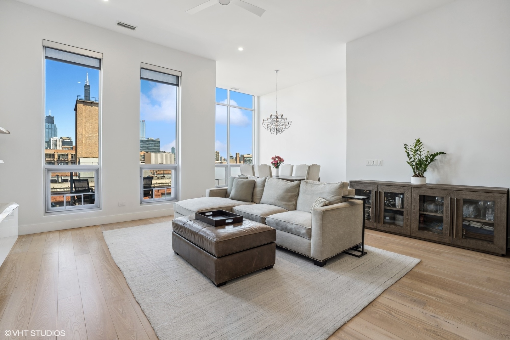 128 South Aberdeen Street, Unit PHN Chicago, IL 60607 - Photo 5 of 43 a living room with furniture and wooden floor