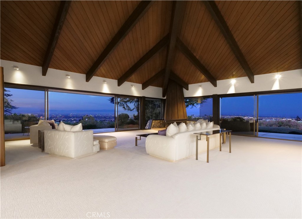 57 Saddleback Road Rolling Hills, CA 90274 - Photo 13 of 38 a view of a patio with dining table and chairs under an umbrella