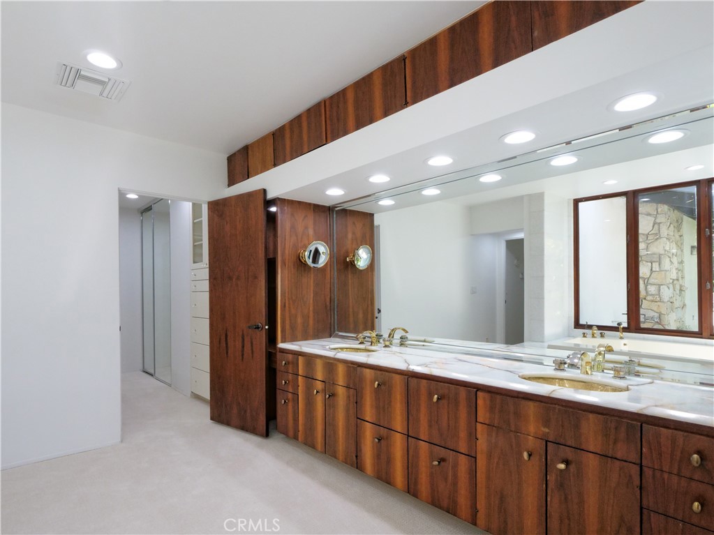57 Saddleback Road Rolling Hills, CA 90274 - Photo 22 of 38 a bathroom with a double vanity sink and a mirror