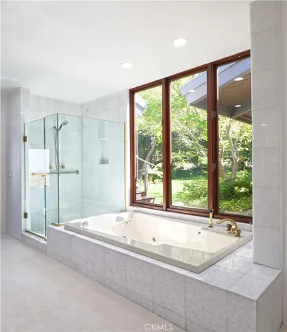 a spacious bathroom with a large tub and shower