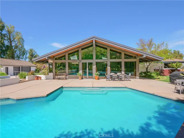 a view of swimming pool with outdoor seating and deck
