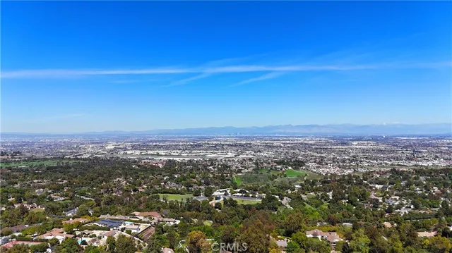 an aerial view of residential houses with city view
