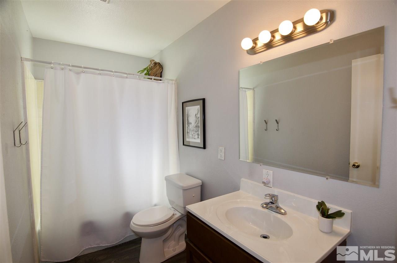 445 Ballentyne Way Reno, NV 89502 - Photo 13 of 25 a bathroom with a sink toilet and mirror