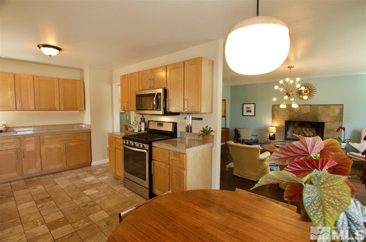 445 Ballentyne Way Reno, NV 89502 - Photo 8 of 25 a bed room with a bed mirror and a fireplace