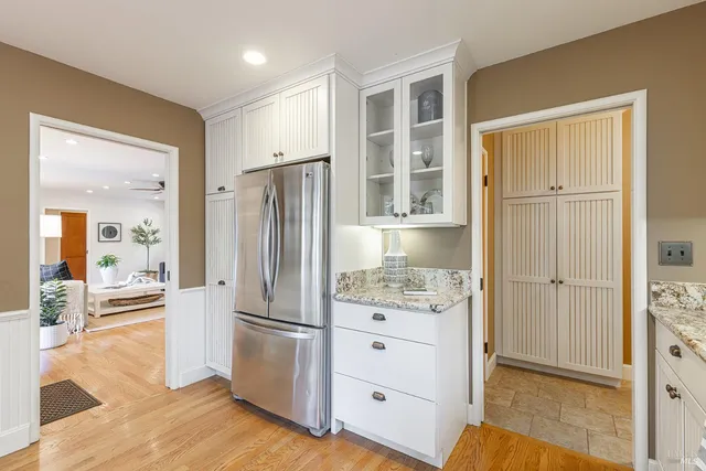 a dining room with furniture window and wooden floor