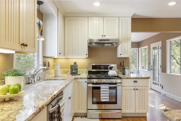 a dining room with furniture window and wooden floor