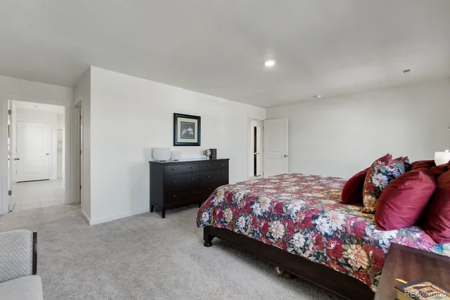 a bedroom with a bed and a couch