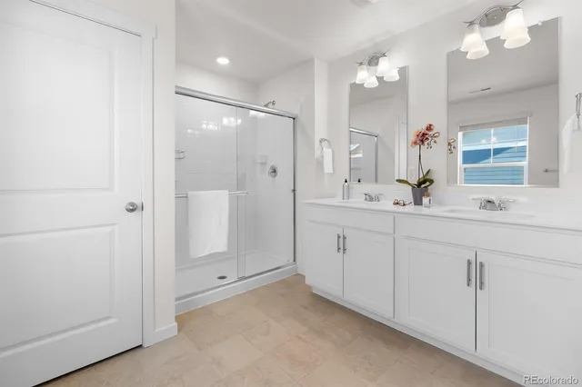a bathroom with a sink vanity and a mirror