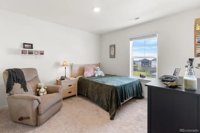 a bedroom with a bed and a dresser