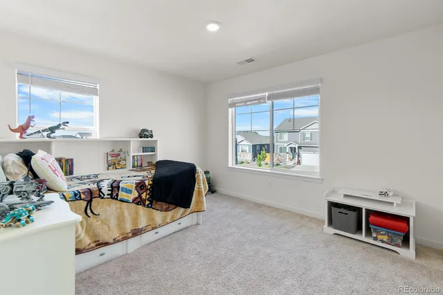 a bedroom with a bed and a potted plant